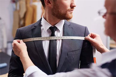 What factors determine the price of tailored suits?