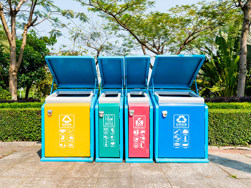 What is the material of the plastic trash bins?
